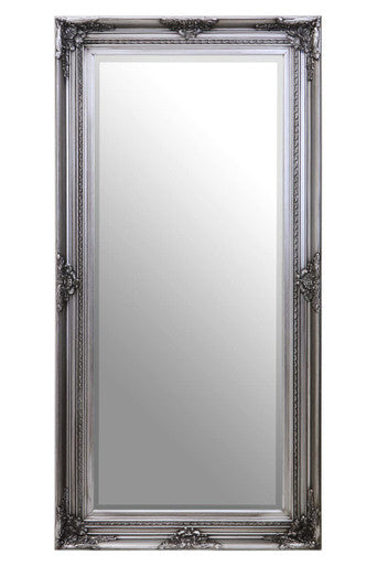 Decorative silver mirror with intricate frame on a white background