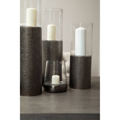 Set of decorative candle holders with candles on a neutral background