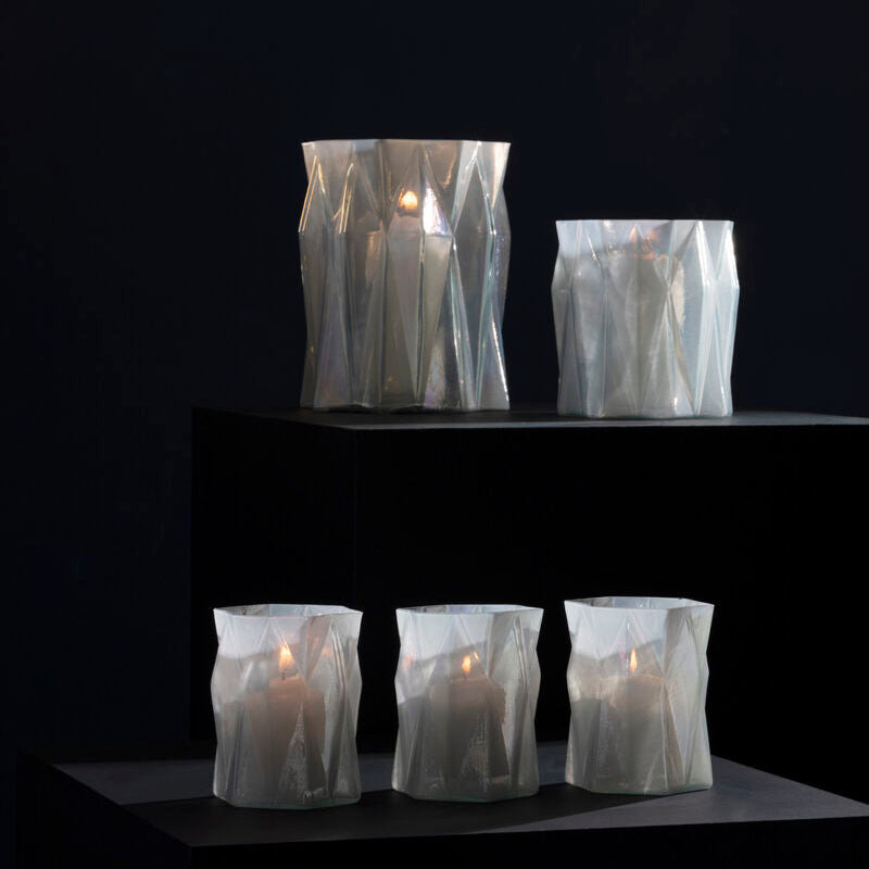 Candles inside clear plastic bags on a dark background