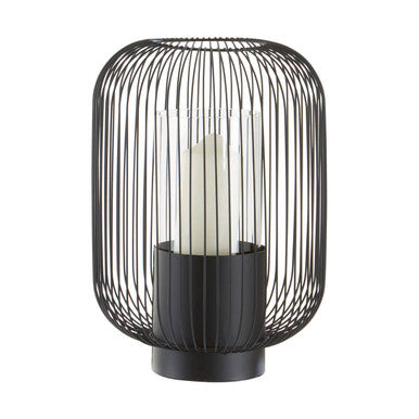 Black wire cage lantern with a candle inside on a white background