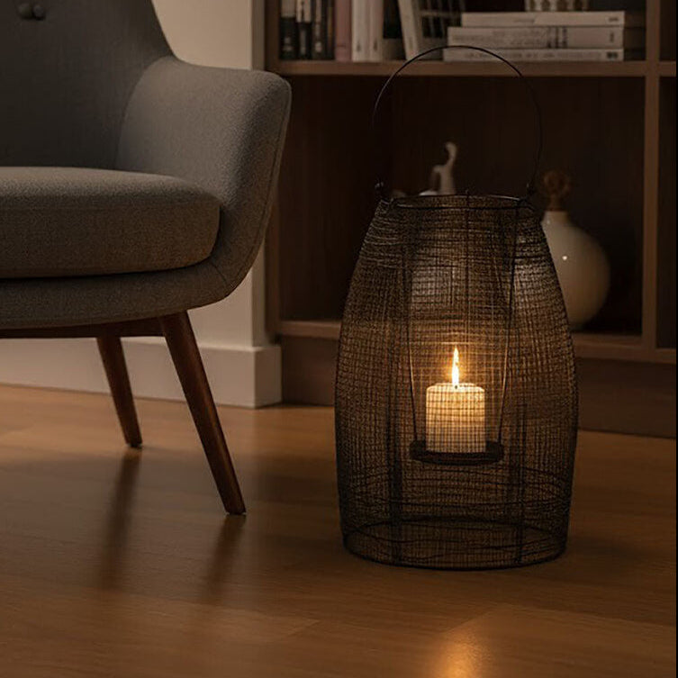 Gray armchair in a room with a bookshelf and candle lantern