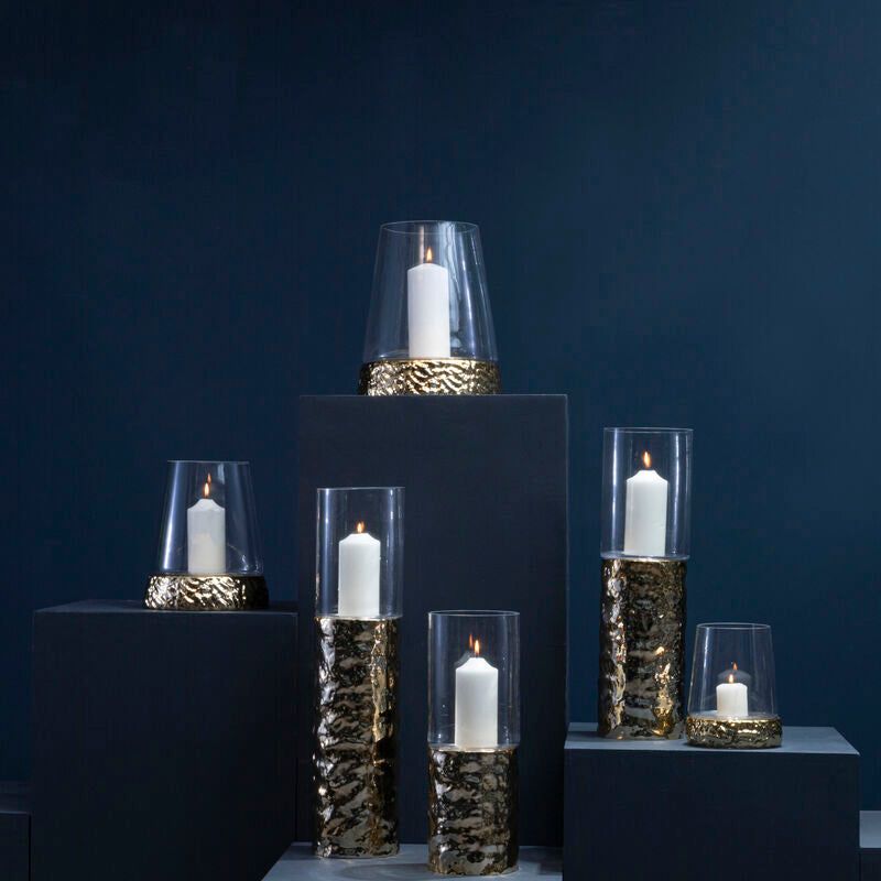 Set of candle holders with candles on a dark blue background