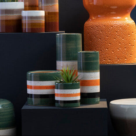 Collection of ceramic vases and planters with a dark blue background