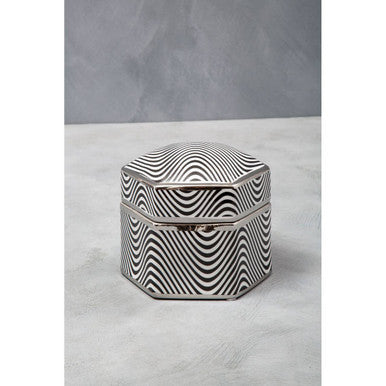 Hexagonal box with black and white wavy pattern on a gray background