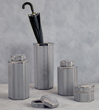 Set of decorative canisters with a black umbrella on a gray background