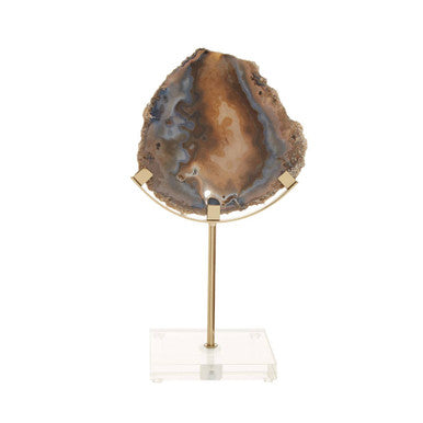 Geode on a gold stand with a white base on a white background