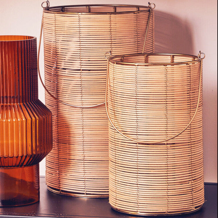 Three decorative vases on a shelf with a neutral background