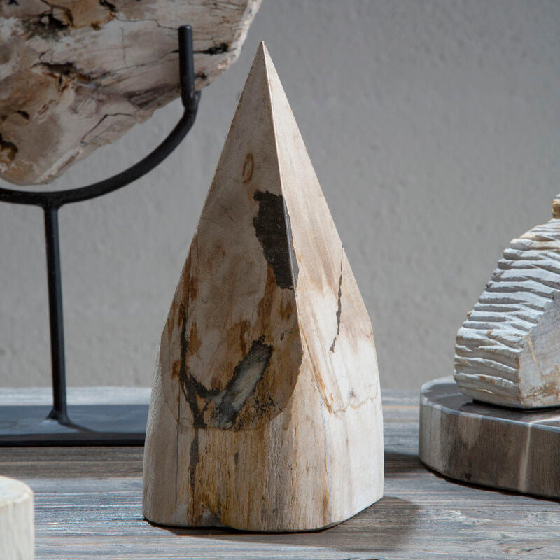 Decorative stone sculpture on a wooden surface with a neutral background