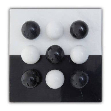 Nine black and white balls arranged in a 3x3 grid on a black and white background.