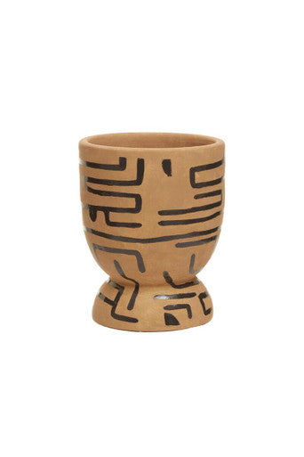 Ceramic cup with black geometric patterns on a white background