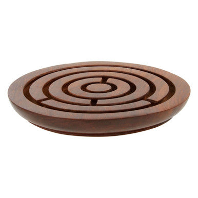 Wooden coaster with concentric circle design on a white background