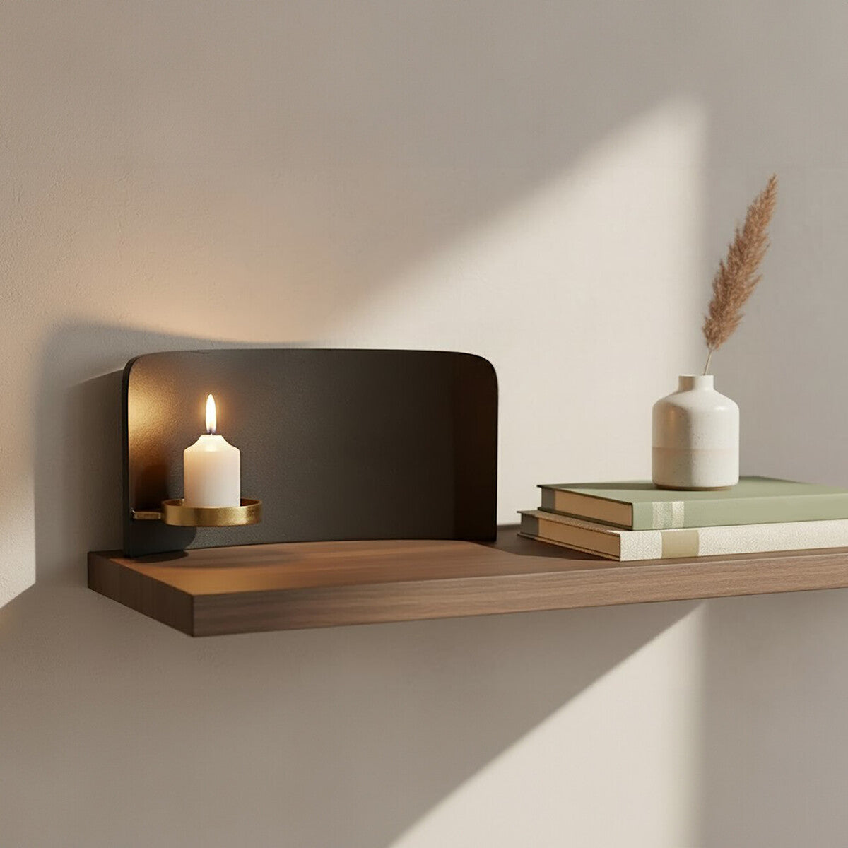 Wooden shelf with a candle, books, and a vase against a neutral wall.