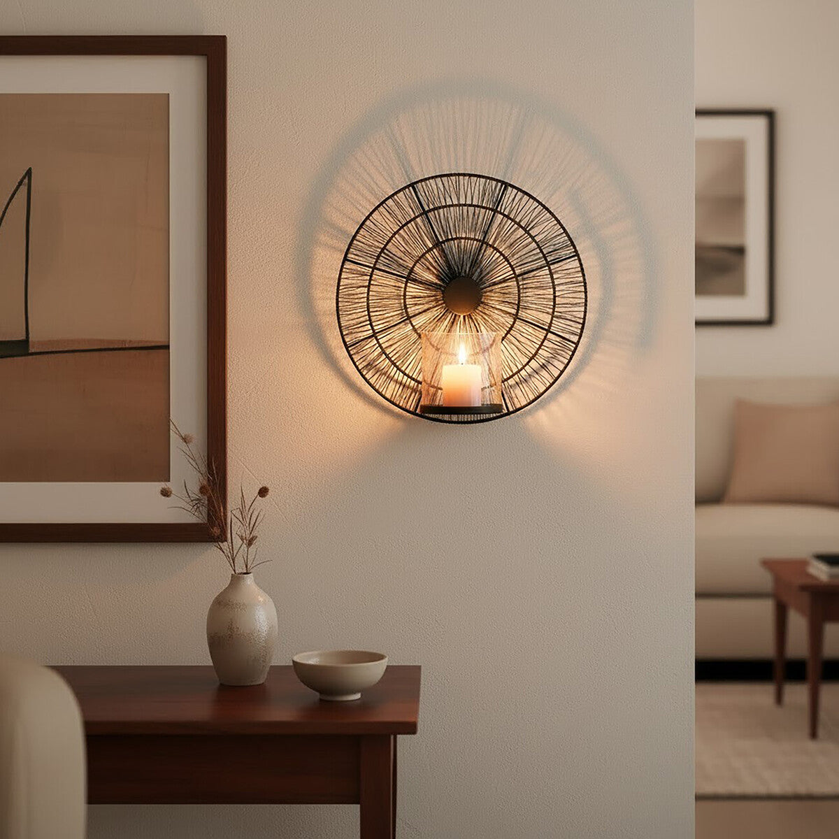 Decorative wall light fixture in a living room setting with a vase and bowl on a table.
