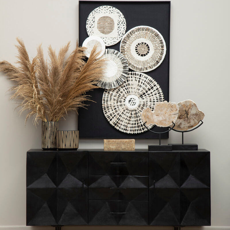 Modern black console table with decorative items against a neutral wall