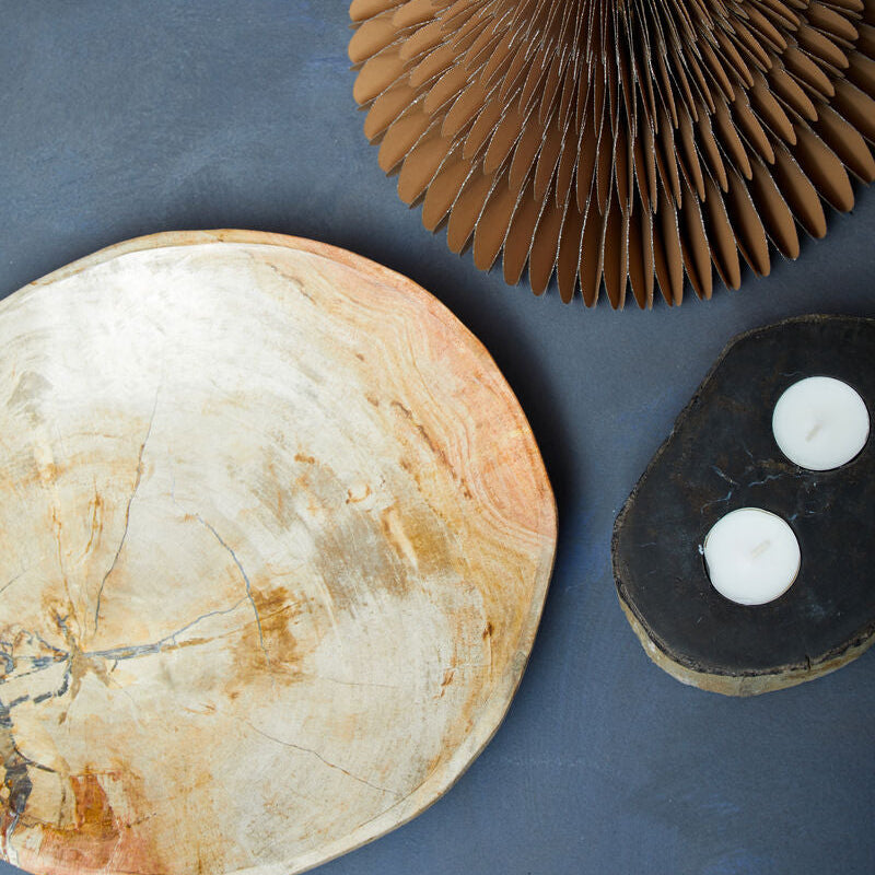 Three natural stone bowls on a blue surface