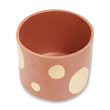 Ceramic cup with white polka dots on a white background