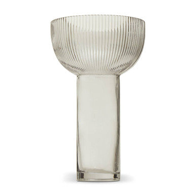 Clear glass vase with ribbed design on a white background