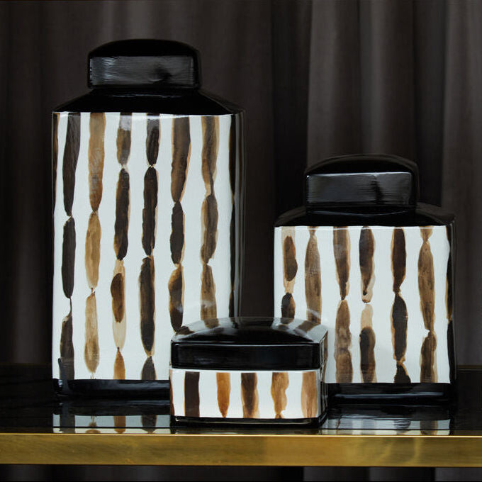Set of decorative jars with a geometric pattern on a dark background