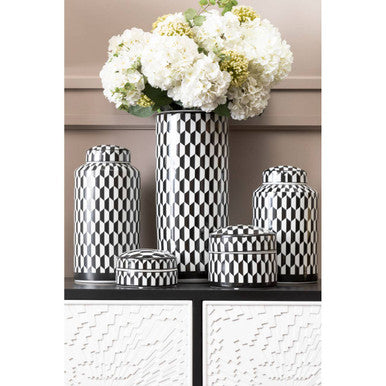 Set of decorative jars with black and white checkered pattern on a shelf.