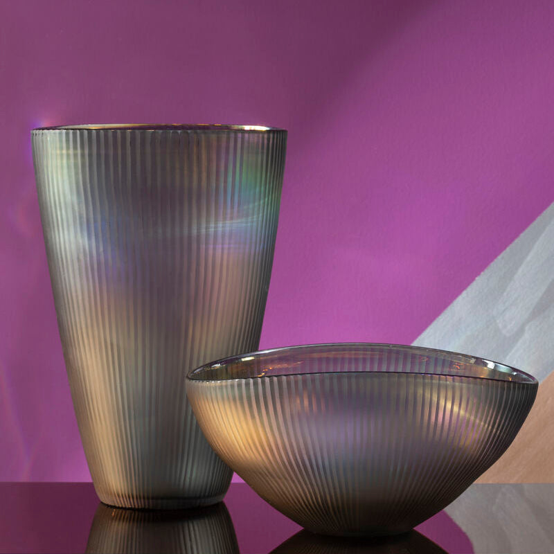 Two metallic vases on a reflective surface with a purple gradient background