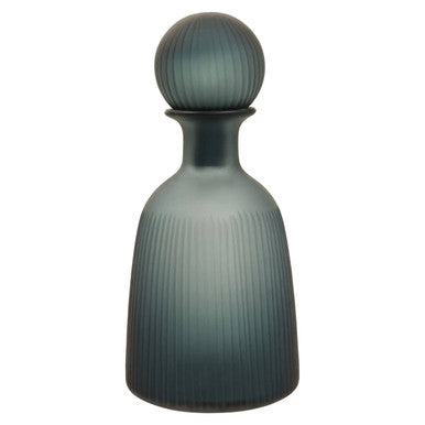 Green glass bottle with ribbed design on a white background
