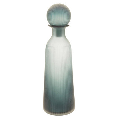 Tall, ribbed glass bottle with a gradient color from light to dark on a white background