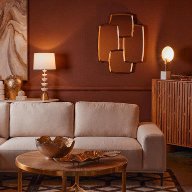 Living room with beige sofa, wooden coffee table, and decorative wall art.