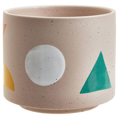 Ceramic cup with geometric shapes on a beige background