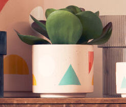 Wooden cabinet with decorative items and a stool in a room setting