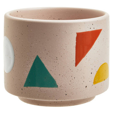 Ceramic cup with geometric shapes on a beige background