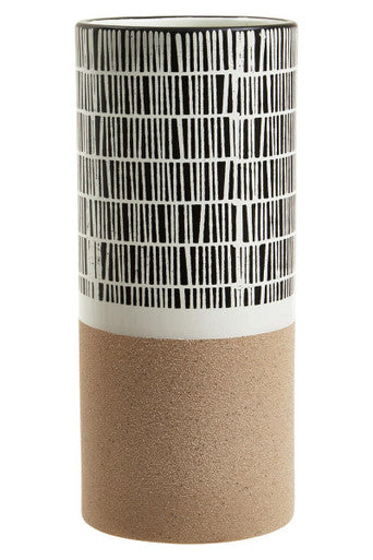 Cylindrical vase with black and white striped pattern and beige base on a white background