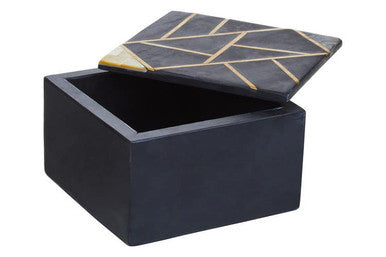 Black storage box with geometric gold lid on a white background