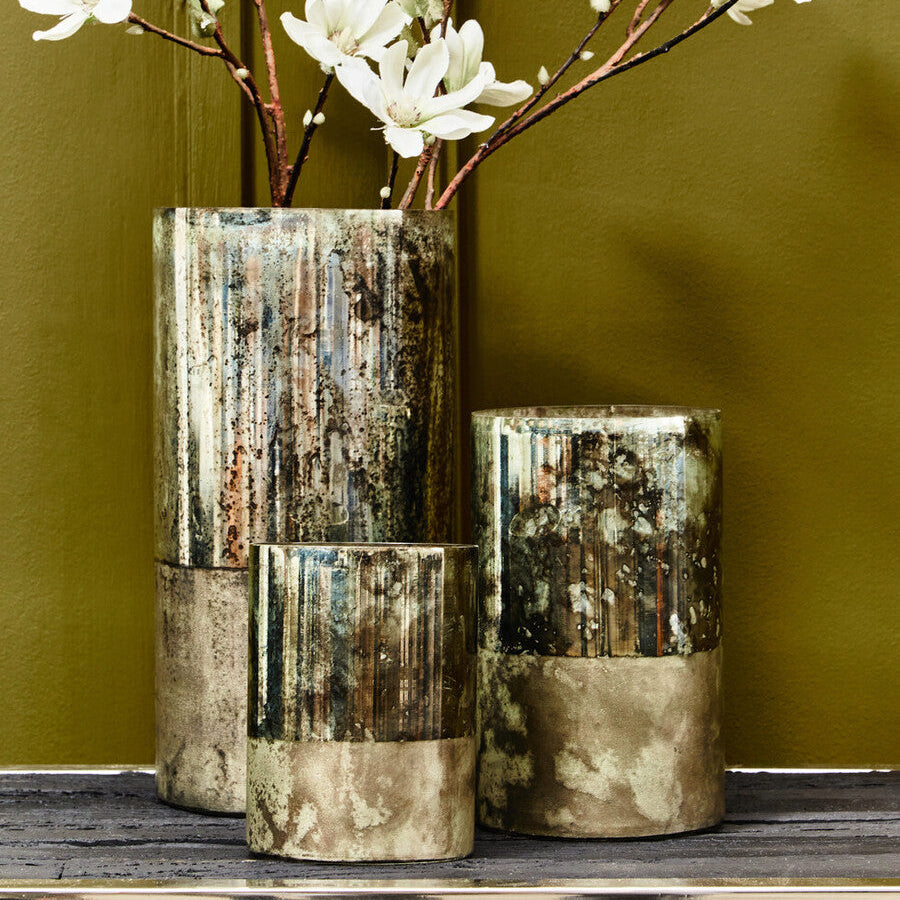 Two decorative vases with a textured, multicolored finish on a green background.
