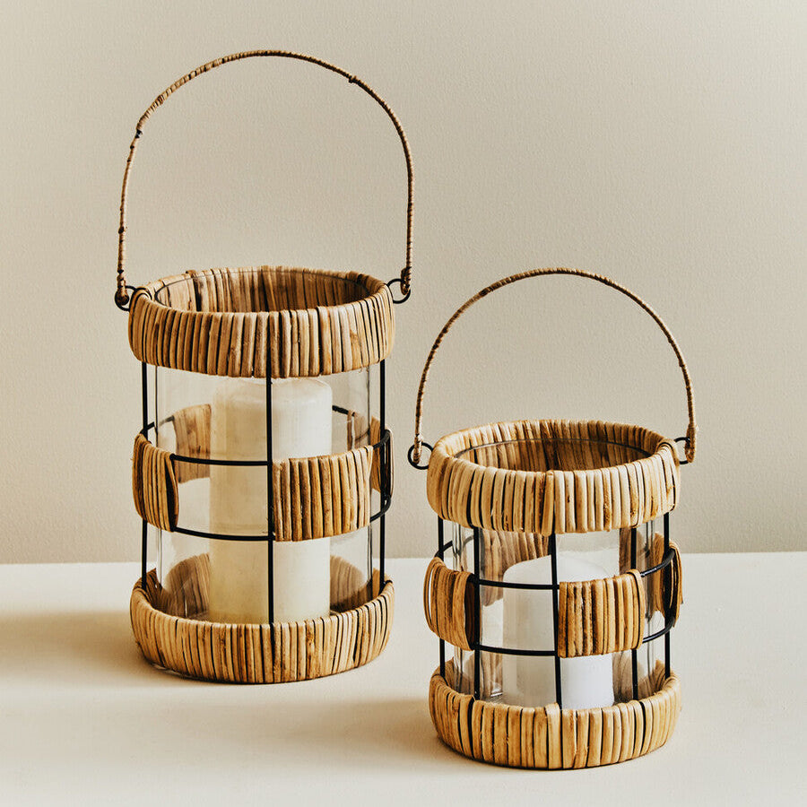 Two wooden lanterns with glass panels on a neutral background