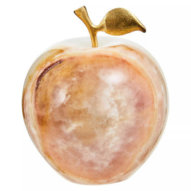 Decorative stone apple with a gold leaf on a white background