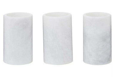 Three cylindrical white filters on a white background