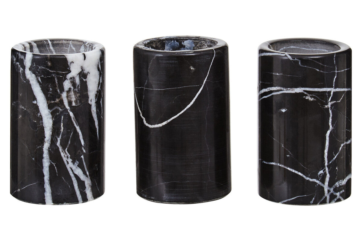 Three black marble cylindrical containers with white veins on a white background
