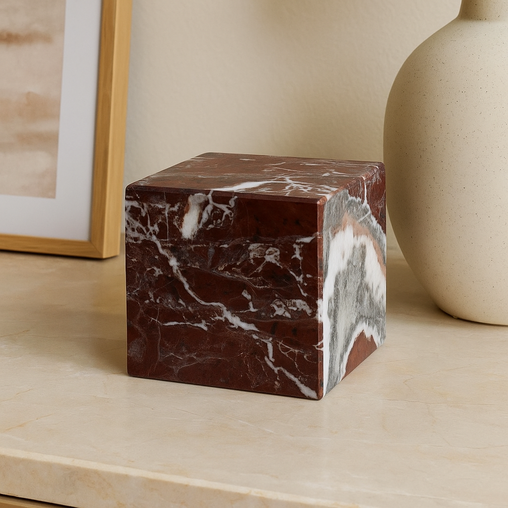 Marble cube on a light wooden surface with a neutral background