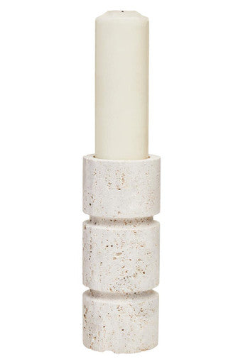 Decorative candle holder with a white candle on a white background
