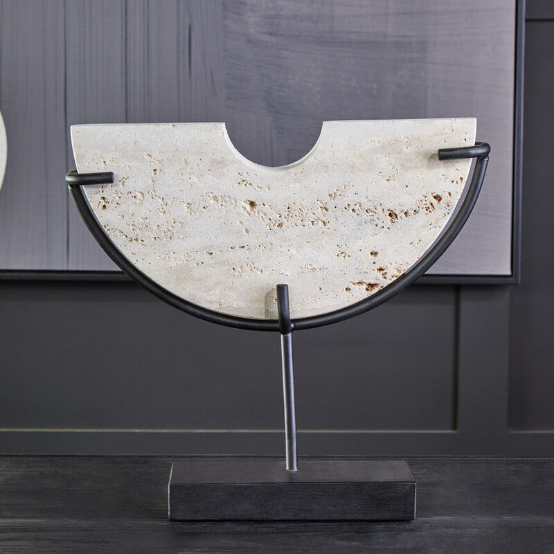 Decorative piece with a stone-like top and metal frame on a dark surface.