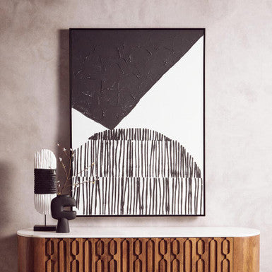 Wooden sideboard with abstract art and decorative items in a room.