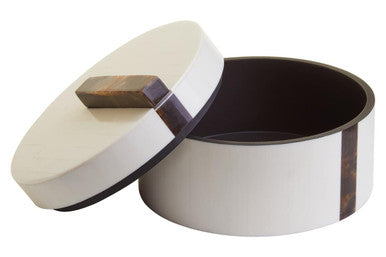 Round metal container with wooden lid on a white background
