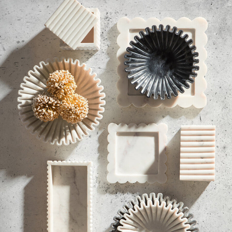 Set of ceramic kitchen tools on a textured surface