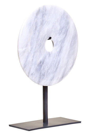 Table lamp with marble-like shade and black base on a white background