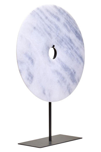 Marble disc sculpture on a stand with a white background