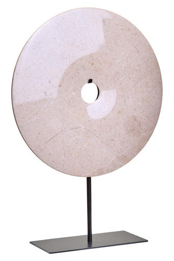 Decorative stone disc on a stand against a white background