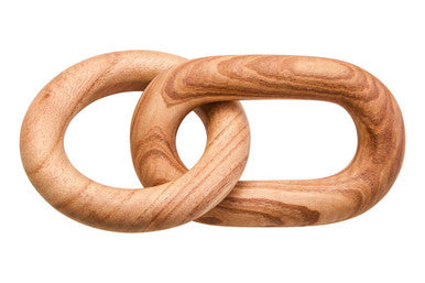 Two interlocking wooden rings on a white background
