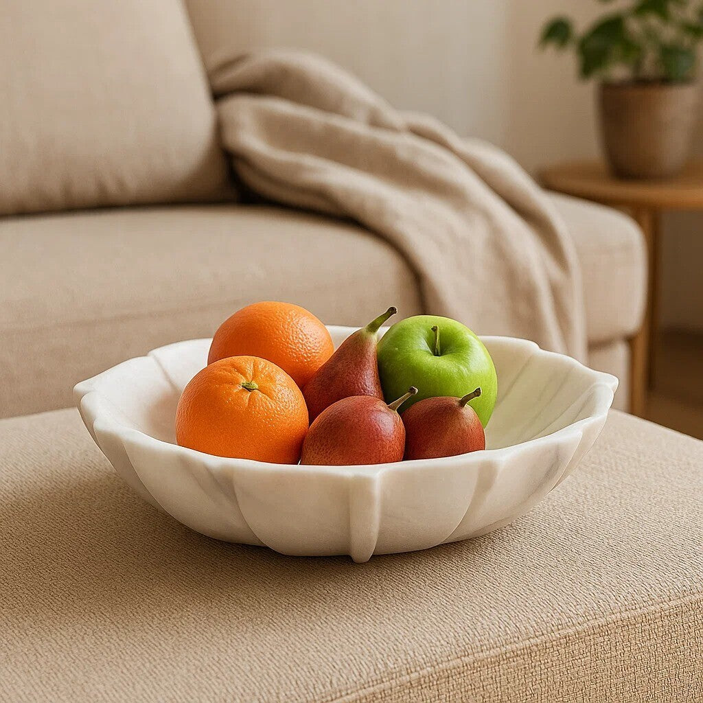 Fruit bowl with oranges, pears, and apples on a beige sofa