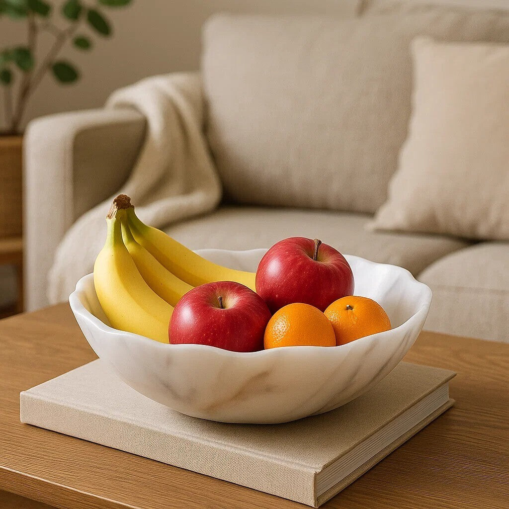 Fruit bowl with bananas, apples, and oranges on a wooden table in a living room.