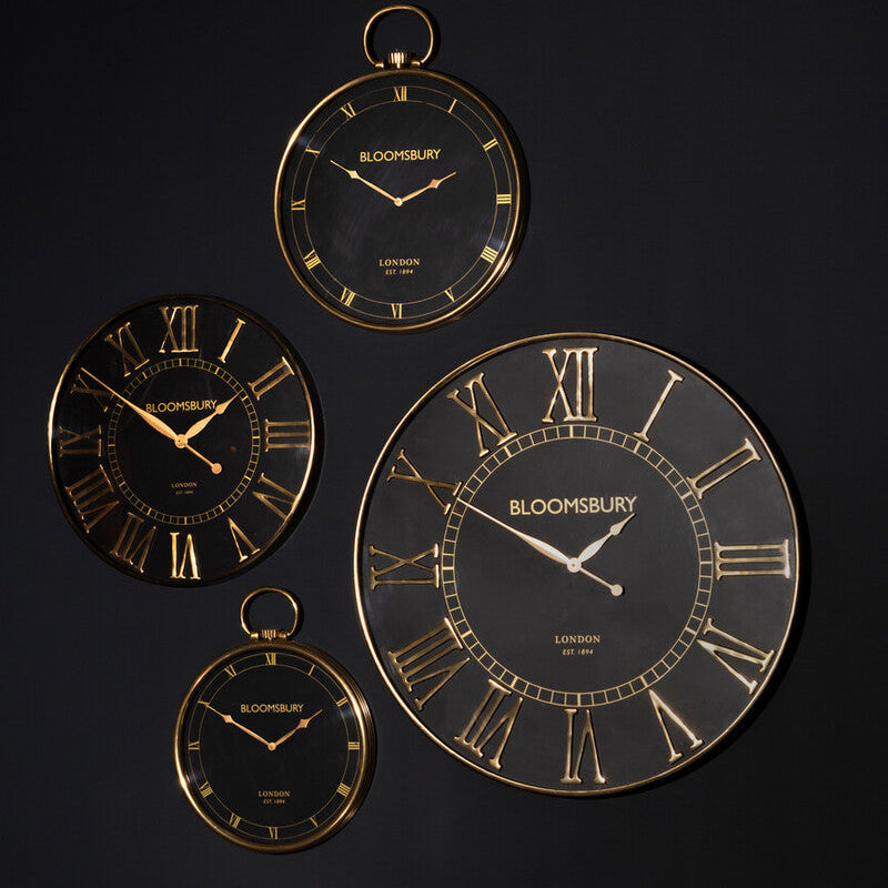 Set of decorative wall clocks with gold accents on a black background